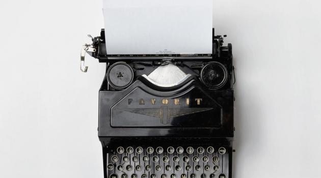Top-down view of black and white typewriter.