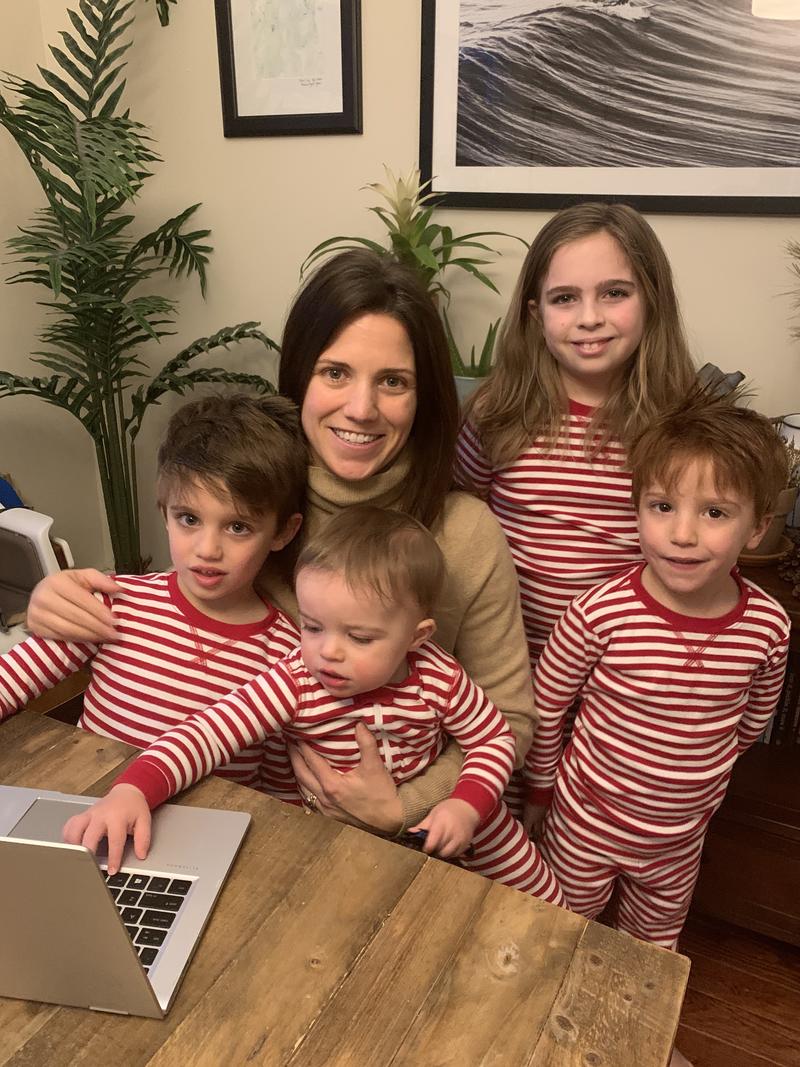 Jackie at her work station (aka kitchen table) with 10-year-old stepdaughter Avery, 5-year-old twins Olney and Marty and 17-month-old Henry.