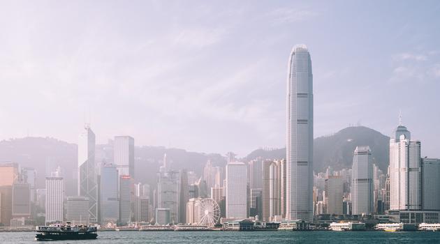 Skyline of Hong Kong with water with a boat in front