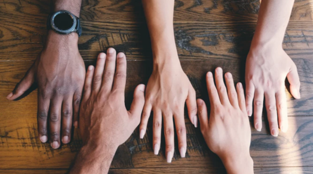 Diverse hands in a row 