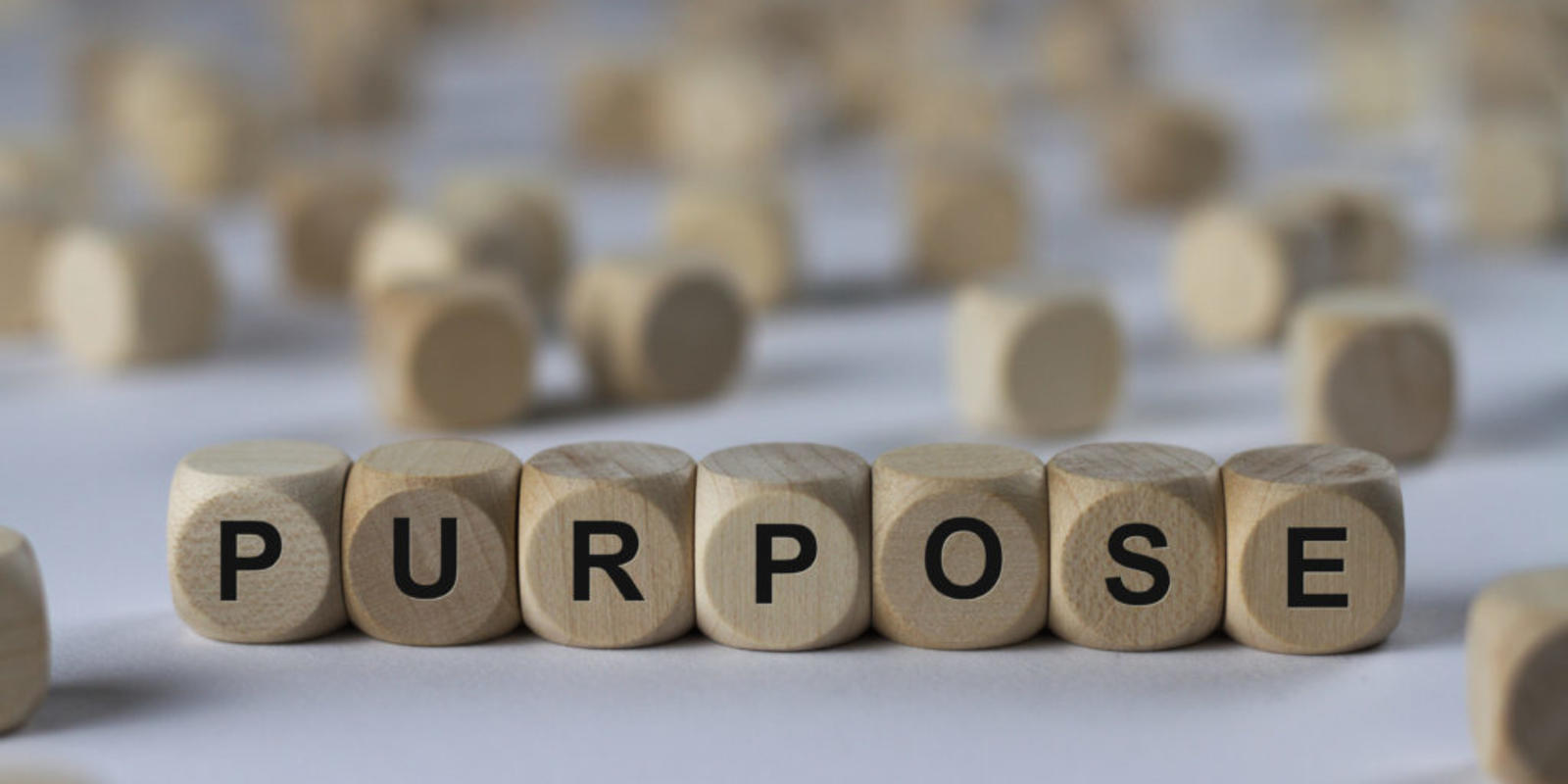 Scrabble game pieces spelling out purpose