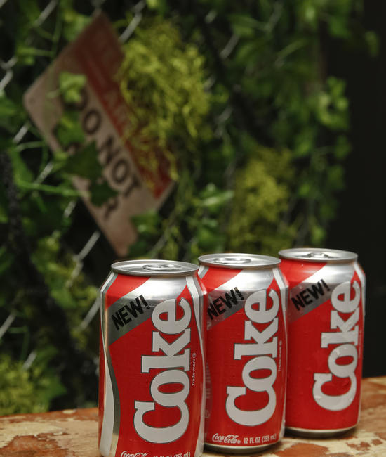 3 Coca-Cola Bottles On a Bench